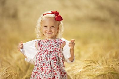 Portrait of a smiling girl on field