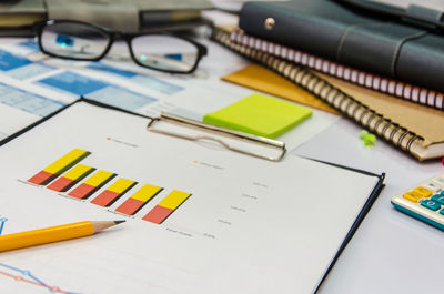 Clipboard with graph chart on table