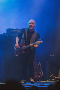 Man playing guitar at music concert