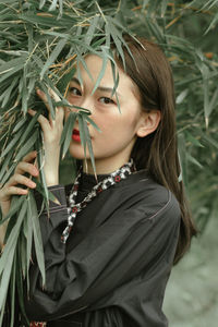 Portrait of woman by plants