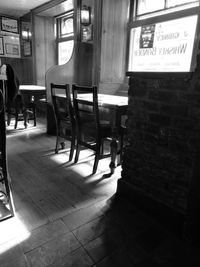 Empty chairs and tables in illuminated building