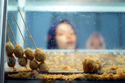 Close-up of ice cream on glass window