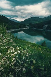 Scenic view of lake and mountains against sky