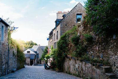 Picturesque old houses in historic centre of dinan. sun flares near sunset