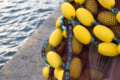 High angle view of buoys on retaining wall by sea