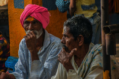 Portrait of two people sitting outdoors