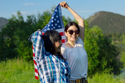 Women with usa flag, celebration of patriotic american national holiday 4th of july independence day