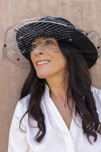 Portrait of young woman wearing hat