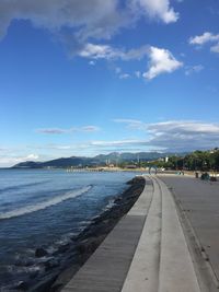 Scenic view of beach against blue sky