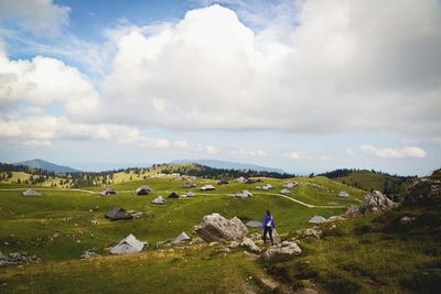 Scenic view of grassy field against cloudy sky