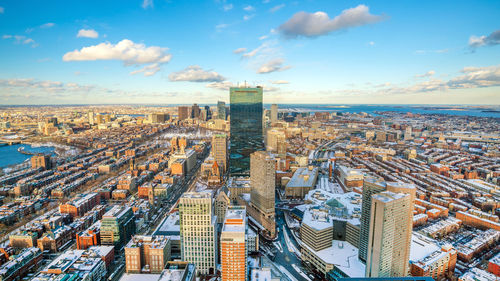 Aerial view of city buildings against sky