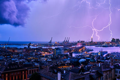 Evening view of genoa port with thunderstorm and lighting, italy