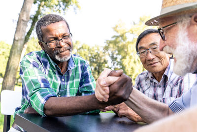 Man smiling while sitting outdoors