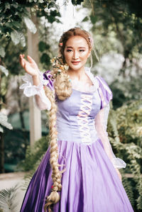 Portrait of smiling young woman standing outdoors