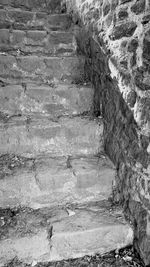 Staircase by stone wall