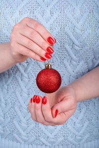 Midsection of woman holding christmas decorations