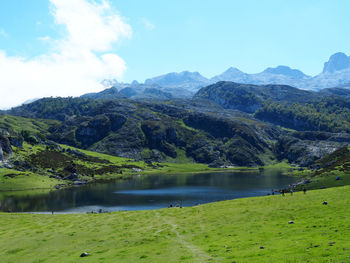 Scenic view of lake and mountains against sky