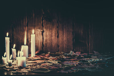 Close-up of illuminated candles on table