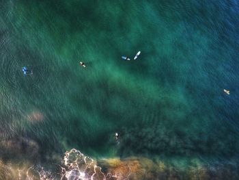 High angle view of illuminated airplane flying over sea