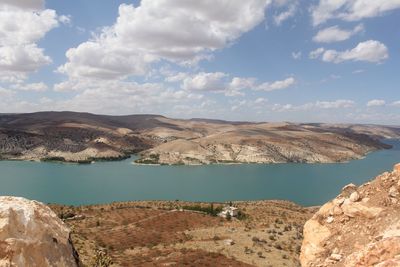 View of calm lake against cloudy sky