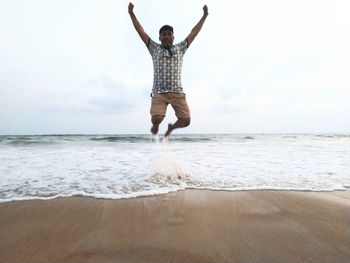 Full length of man on beach against sky