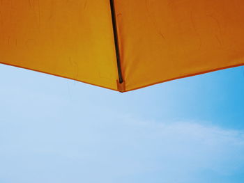 Cropped image of yellow umbrella against sky