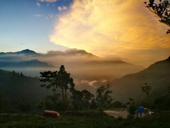 Scenic view of field and mountains against sky