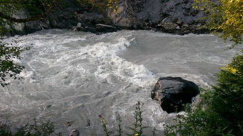 High angle view of waterfall along trees