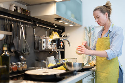 Woman standing in kitchen at home