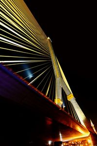 Low angle view of illuminated suspension bridge