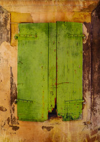 Close-up of old weathered door of building
