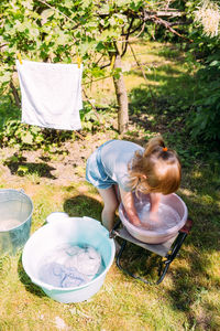 High angle view of woman sitting on field