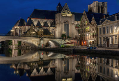 Reflection of st michaels bridge and historic buildings in canal at night