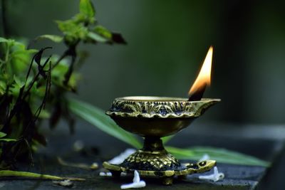 Close-up of illuminated diya against blurred background