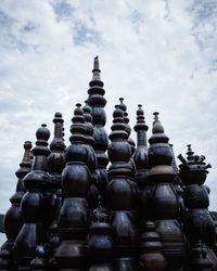 Stack of buddha statues in row against sky