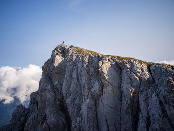 Low angle view of rocky mountain against sky