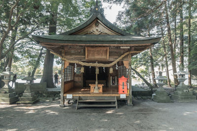 Traditional building against trees in forest