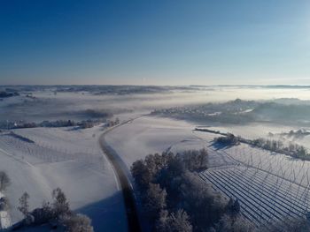 Aerial view of snowcapped landscape against sky