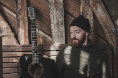 Portrait of young man playing guitar