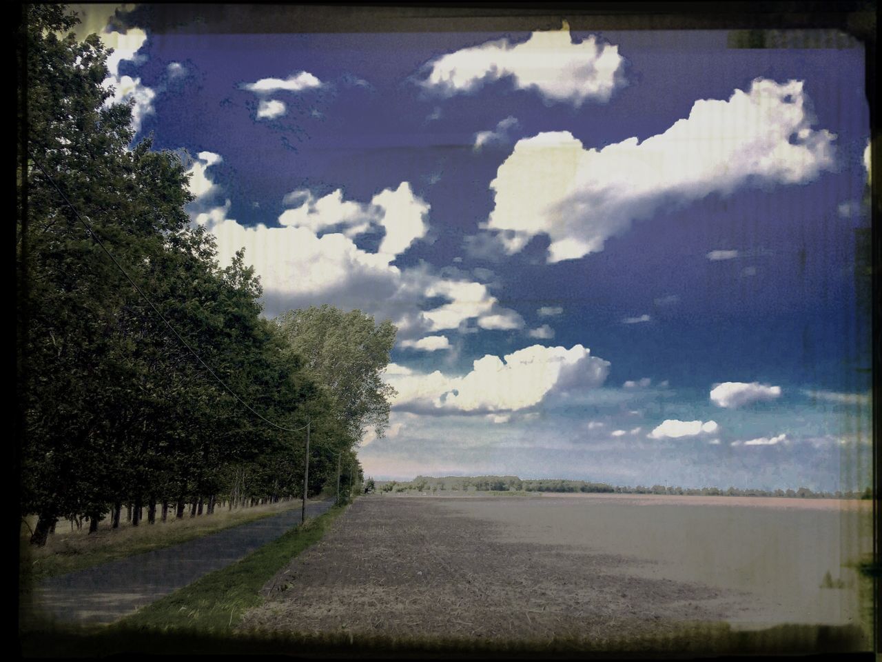 sky, transfer print, cloud - sky, tranquil scene, tranquility, water, tree, cloud, auto post production filter, cloudy, scenics, nature, landscape, beauty in nature, road, field, transportation, day, grass, lake