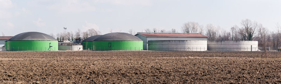 Barn on field against sky