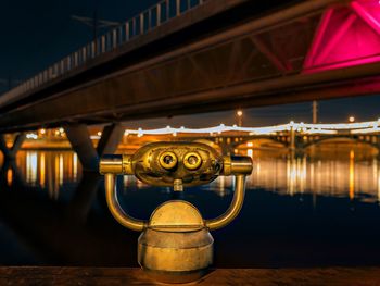 Coin-operated binoculars by lake at night