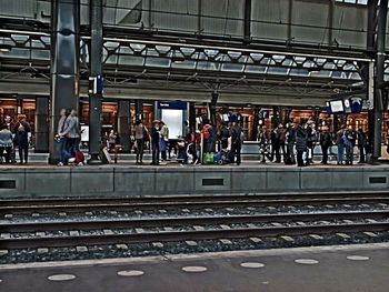 People waiting at railroad station platform