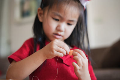 Close-up of cute girl making decoration