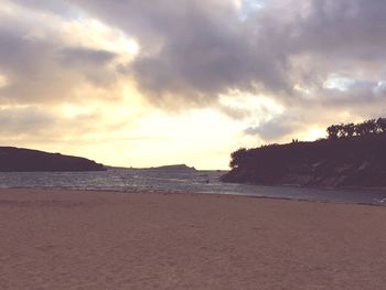 Scenic view of beach against sky during sunset