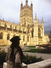 Woman standing against historic building 