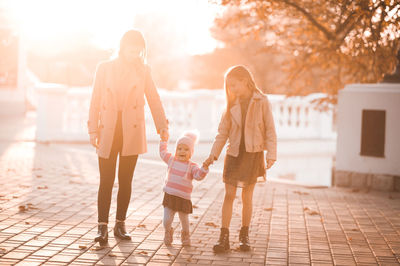 Girls with sister standing of street