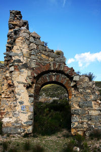 Low angle view of old ruins against sky