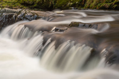 Blurred motion of water flowing through rocks
