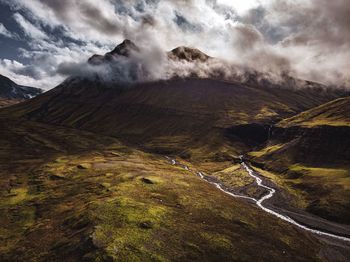 Scenic view of valley and mountains against sky